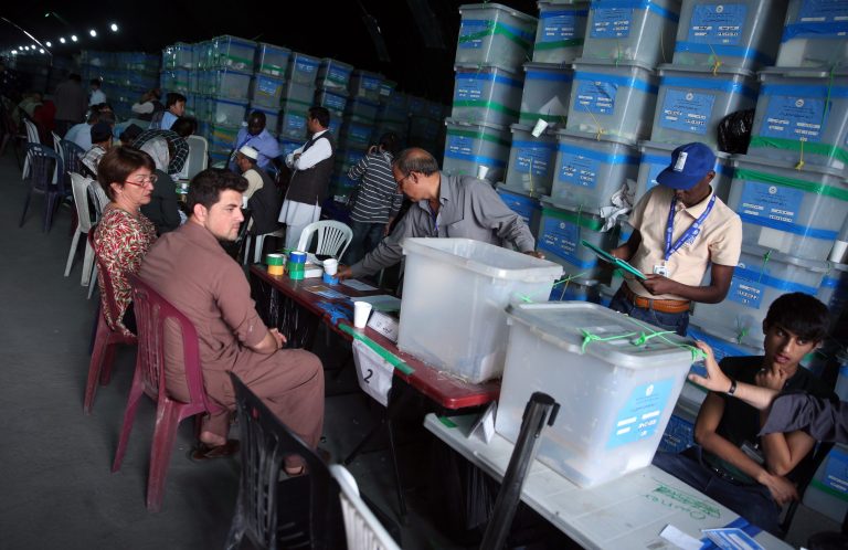 Afghan election commission workers sort ballots for an audit of the presidential run-off votes in front of international observers at an election commission office in Kabul, Afghanistan, Wednesday, Aug. 27, 2014.  One of two men vying to become the president of Afghanistan, Abdullah Abdullah, pulled his observers Wednesday from an audit of the country's disputed election over concerns of widespread fraud in a move that throws the already contentious election into further crisis.  (AP Photo/Massoud Hossaini)