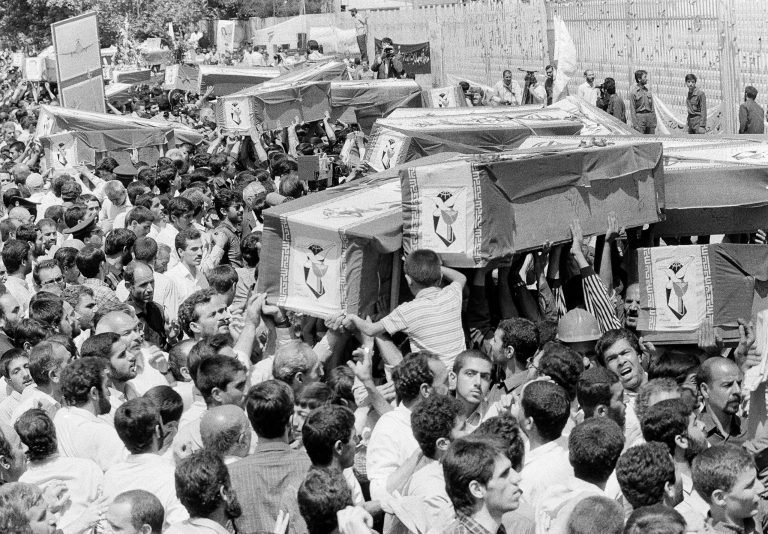 Mourners carry coffins through the streets of Tehran, July 7, 1988, during a mass funeral for victims who died in the Iran Air Flight 655 crash in the Persian Gulf, which was brought down by the USS Vincennes on July 3. (AP Photo)