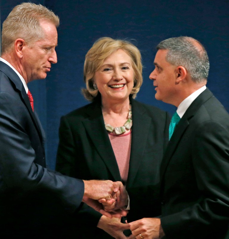 Former Secretary of State and Sen. Hillary Rodham Clinton, center, greets Richare Alles, financial secretary of the Uniformed Firefighters Association, left, and Mario Cilento, president of the New York State AFL-CIO, before speaking to advocates, emergency workers who responded to the 9/11 terrorist attacks, survivors of the attacks and union members and officials during a fundraiser marking last week's 13th anniversary of the attacks at a benefit for Citizens for the Extension of the James Zadroga Act and 9/11 Health Watch in New York, Tuesday, Sept. 16, 2014. (AP Photo/Kathy Willens)