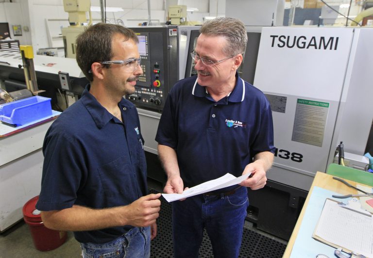  In this Monday, June 11, 2012, photo, John Maurer, right, chief of operations for Esterline & Sons Manufacturing, talks with operator Jeff Harris inside the manufacturing facility, in Springfield, Ohio. Small businesses like Esterline & Sons that make machines and components for other manufacturers are on an upswing that could be a harbinger of things to come for the broader economy. (AP Photo/Al Behrman)  