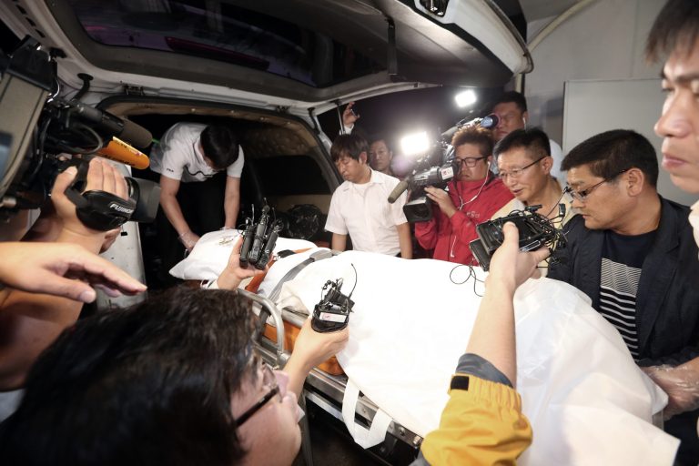 The body of a man believed to be the fugitive owner of the sunken ferry Sewol is carried into an ambulance at a funeral hall in Suncheon, South Korea, Tuesday, July 22, 2014. South Korean police said Tuesday that they have found the body of a fugitive billionaire businessman sought over April's ferry disaster that left more than 300 people dead or missing.(AP Photo/Yonhap, Park Chul-hong)  KOREA OUT