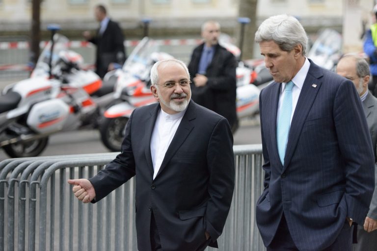 In this file photo taken Wednesday, Jan. 14, 2015, U.S. Secretary of State John Kerry, right, speaks with Iranian Foreign Minister Mohammad Javad Zarif, as they walk in Geneva, Switzerland, ahead of the next round of nuclear discussions. (AP Photo/Keystone, Laurent Gillieron, File)