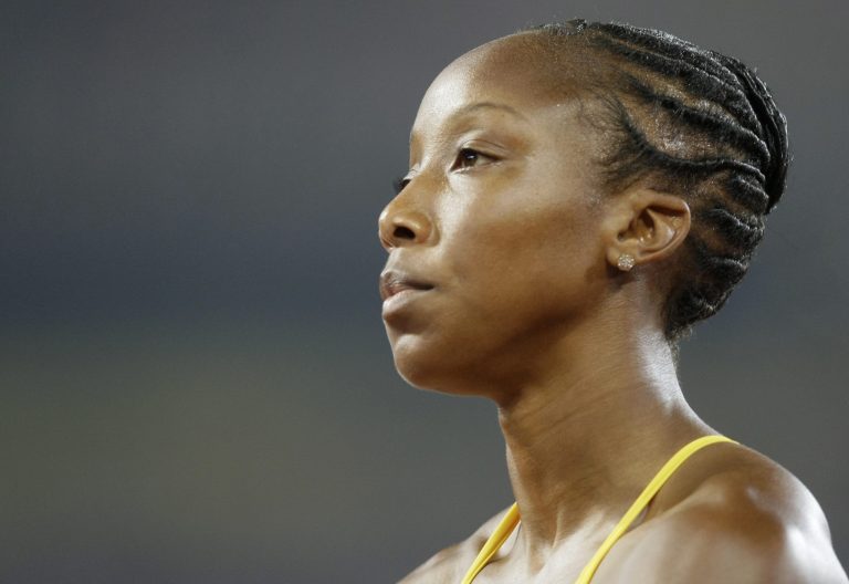 FILE - In this Aug. 19, 2008 file photo, Sherone Simpson of Jamaica at the end of a women's 200-meter heat in the National Stadium at the Beijing 2008 Olympics in Beijing. The Jamaican Olympic sprinter was banned from her sport Tuesday, April 8, 2014, until Dec. 20 after testing positive for a banned substance. (AP Photo/Anja Niedringhaus, File)