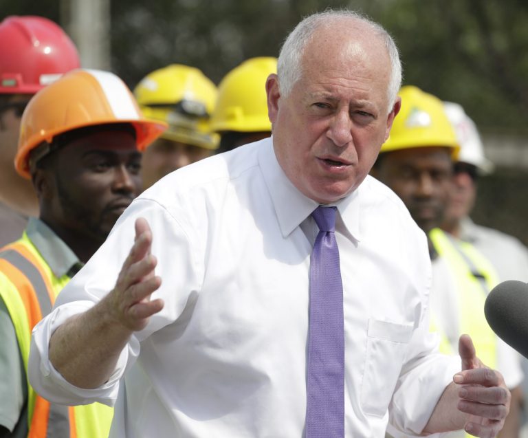Gov. Pat Quinn, surrounded by workers, speaks during a signing ceremony in Chicago on Tuesday, July 22, 2014 for an approximately $1 billion capital spending plan intended to create jobs and help repair Illinois roads and bridges after a harsh winter. (AP Photo/M. Spencer Green)