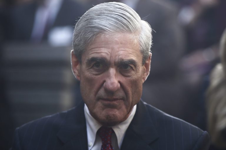 FILE - In this Oct. 28, 2013, file photo, former FBI Director Robert Mueller is seated before President Barack Obama and FBI Director James Comey arrive at an installation ceremony at FBI Headquarters in Washington. A Washington restaurant announced on Nov. 1, 2017, it is offering a special $5 
