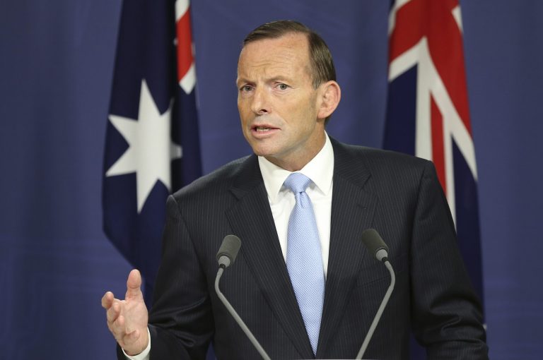 FILE - In this Feb. 7, 2014 file photo, Australia's Prime Minister Tony Abbott speaks at a press conference with New Zealand Prime Minister John Key at the Commonwealth Parliamentary offices in Sydney, Australia. Abbott says he will spend a week in an Outback Aboriginal settlement to focus national attention on the bleak plight of indigenous people. Abbott announced his trip to remote East Arnhem Land, to be made sometime later this year, in a speech to Parliament on Wednesday, Feb. 12, 2014. (AP Photo/Rob Griffith, File)