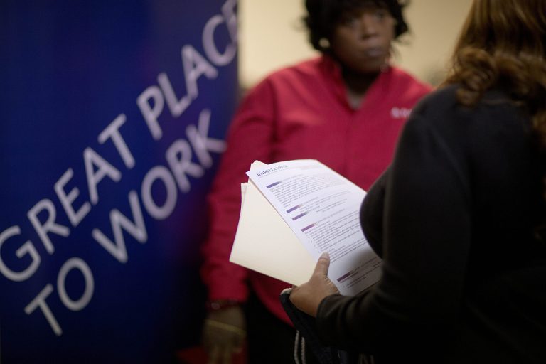 FILE - In this  Thursday, Nov. 14, 2013, file photo, Jimmetta Smith, of Lithonia, Ga., right, the wife of a U.S. Marine veteran, holds her resume while talking with Rhonda Knight, a senior recruiter for Delta airlines, at a job fair for veterans and family members at the VFW Post 2681, in Marietta, Ga.  Payroll processor ADP issues its report on job growth among private companies in December on Wednesday, Jan. 8, 2014. (AP Photo/David Goldman, File)