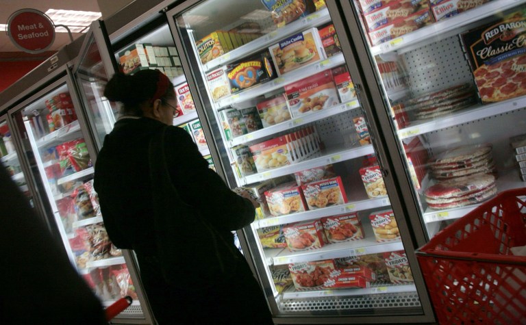 FILE - In this Jan. 11, 2010 file photo, a shopper looks over frozen foods selections at a supermarket in New York. With sales slipping in the category, frozen food makers are in the final stages of preparing a major public relations campaign to defend the nutritional reputation of their products. The push will include what is said to be the first national TV ads on behalf of the industry as a whole, as well as social media and in-store promotions. (AP Photos/Bebeto Matthews, File)