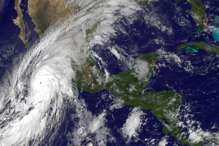 AÂ satellite image taken at 10 a.m. EDT on Friday, Oct. 23, 2015, and released by the National Oceanic and Atmospheric Administration showing Hurricane Patricia, left, moving over Mexico's Pacific Coast. Hours before it hit land, the National Hurricane Center warned of aÂ 