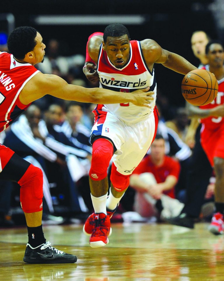 Richard Lipski/AP
John Wall finished with 14 points and four assists in his first game this season as the Wizards beat the Hawks on Saturday.