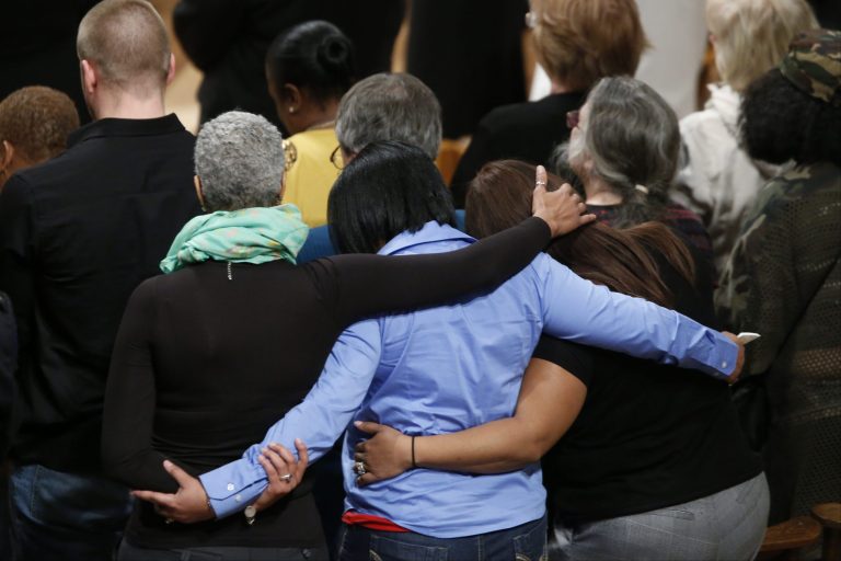 Family members of gun violence embrace each other as they hold a vigil for victims of the shooting at Sandy Hook Elementary School in Newtown, Conn., and other victims of gun violence, Thursday, Dec. 12, 2013, at the National Vigil for Victims of Gun Violence at the National Cathedral in Washington. The one year anniversary of the Newtown, Conn. shootings is December 14. (AP Photo/Charles Dharapak)