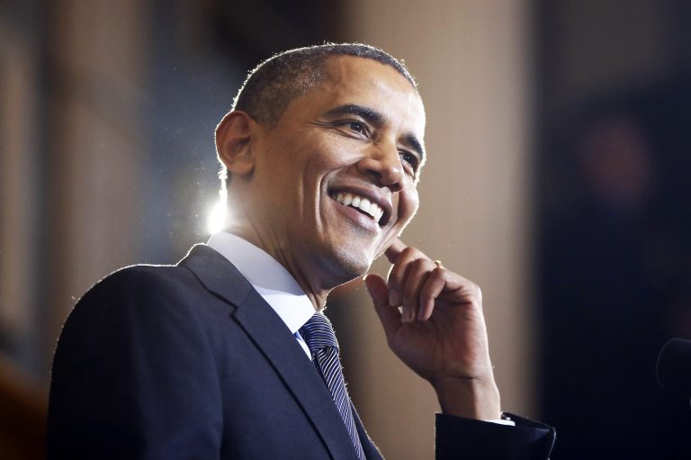 President Barack Obama smiles after he said that environmental protesters who interrupted his speech were at the wrong event as he speaks at Boston's historic Faneuil Hall about the federal health care law, Wednesday, Oct. 30, 2013. Faneuil Hall is where former Massachusetts Republican Gov. Mitt Romney, Obama's rival in the 2012 presidential election, signed the state's landmark health care law in 2006, with top Democrats standing by his side. (AP Photo/Charles Dharapak)