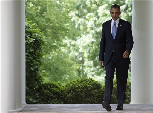 President Barack Obama walks to the Rose Garden of the White House in Washington, Thursday, May 2, 2013, to announce that he will nominate longtime fundraiser and philanthropist Penny Pritzker to run the Commerce Department and economic adviser Michael Froman as the next U.S. Trade Representative. (AP Photo/Carolyn Kaster)