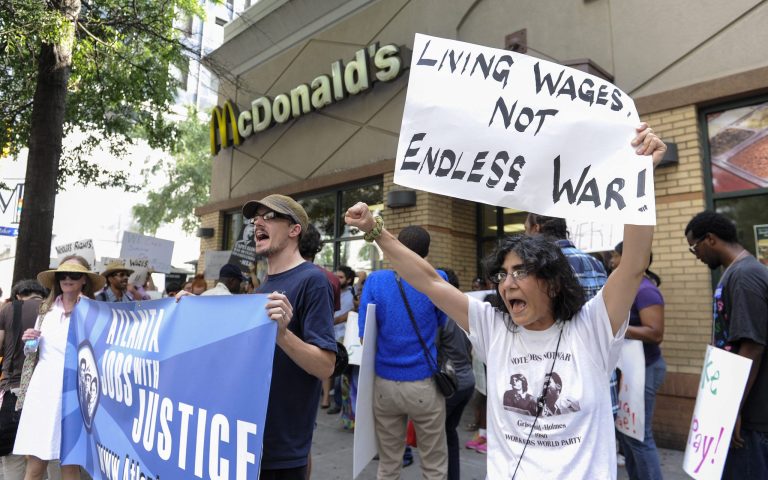  Azi Ebrahimi, right, demonstrates for higher wages for fast-food industry workers during a one-day strike coinciding with strikes at other fast-food restaurants across the country on Thursday, Aug. 29, 2013, in Atlanta.  