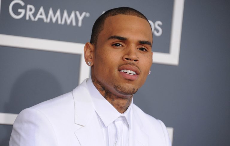 FILE - In this Feb. 10, 2013 file photo, Chris Brown arrives at the 55th annual Grammy Awards, in Los Angeles. Brown was arrested early Sunday, Oct. 27, 2013 in Washington after a fight broke out near the W Hotel near the White House. District of Columbia Police spokesman Officer Paul Metcalf says 24-year-old Brown was arrested and charged with felony assault. Metcalf says 35-year-old Chris Hollosy also was arrested on felony assault charges after the incident.   (Photo by Jordan Strauss/Invision/AP, File)