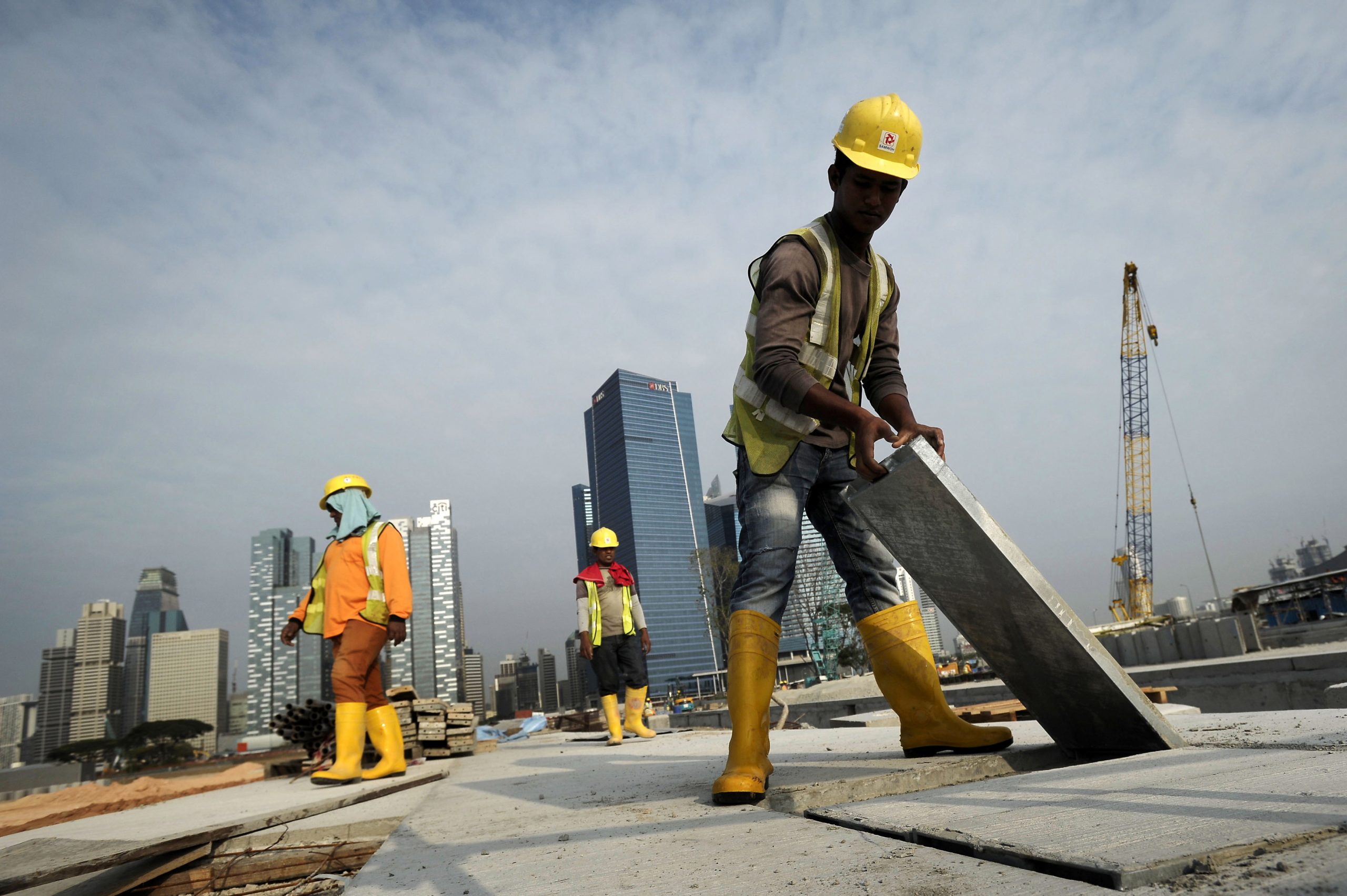 Migrants say firms force workers out of Singapore