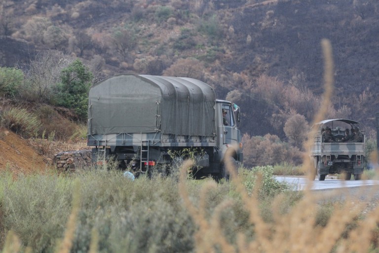 Algerian military trucks are pictured in the Tizi Ouzou region, northern Algeria, on Wednesday, Sept. 23, 2014, as troops conduct search operations in the bid to find French hostage, Herve Gourdel, who was kidnapped by militants. The Algerian extremists allied with the Islamic State group have decapitated a French hostage after France carried out airstrikes in Iraq, according to a video that appeared online Wednesday. French President Francois Hollande condemned the killing of Herve Gourdel and said France would continue its fight against the Islamic State group, which are Sunni militants that have taken over large swaths of Iraq and Syria. (AP Photo)