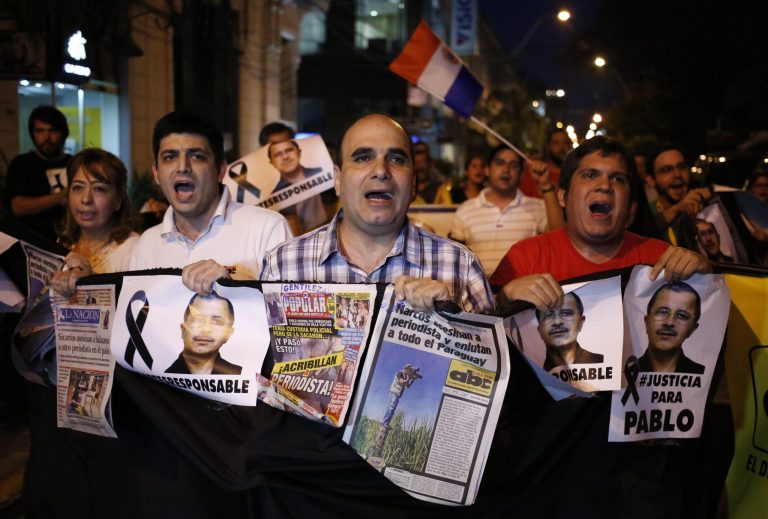 Journalists protest to demand justice for their murdered colleague Pablo Medina, in Asuncion, Paraguay, Friday, Oct. 17, 2014. The 53-year-old reporter was killed Thursday in a crime-ridden northern area that is a hotbed for drugs and arms smuggling. He worked for the newspaper ABC Color and focused on investigations exposing corruption and drug traffickers. The newspaper where Medina worked said Friday that he was investigating drug gangs with suspected links to Paraguayan politicians. (AP Photo/Jorge Saenz)