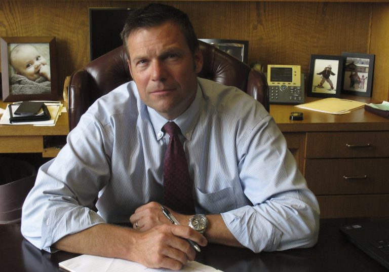 In this photo from Thursday, Aug. 1, 2013, Kansas Secretary of State Kris Kobach, the architect of the state's proof-of-citizenship law for new voters, is photographed during an Associated Press interview in Topeka, Kan. Kobach initiated a lawsuit by Kansas and Arizona against a federal agency to force the modification of a national voter registration form to help the states enforce their proof-of-citizenship laws. (AP Photo/John Hanna)