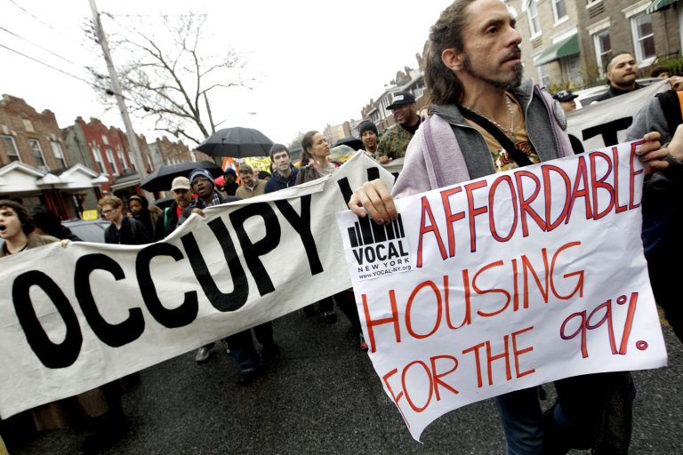 Occupy Wall Street activists march during a tour of foreclosed homes in the East New York neighborhood of the Brooklyn borough of New York. New York Mayor Bill de Blasio has an ambitious plan to build or preserve 200,000 affordable units of housing over the next 10 years for lower-income New Yorkers, a staggering number that would house a population bigger than cities such as Atlanta or Minneapolis. (AP Photo/Mary Altaffer, File)