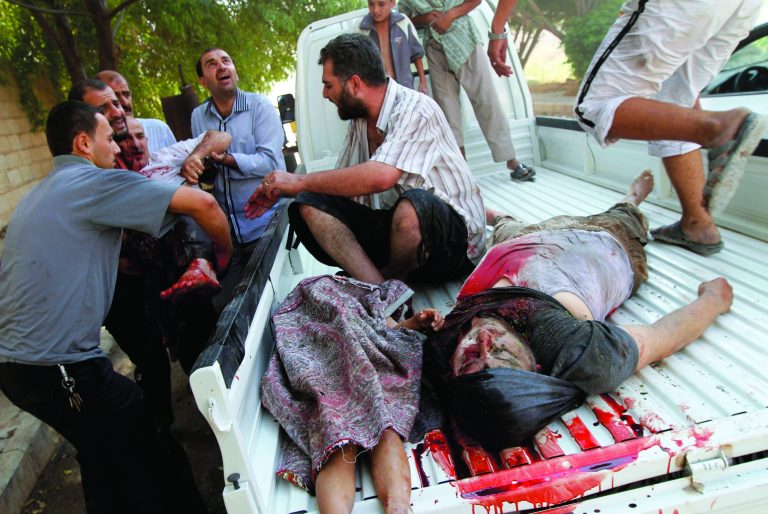 Dead and injured Syrians arrive at a field hospital after an air strike hit their homes in the town of Azaz on the outskirts of Aleppo, Syria, Wednesday, Aug. 15, 2012. (AP Photo/Khalil Hamra)