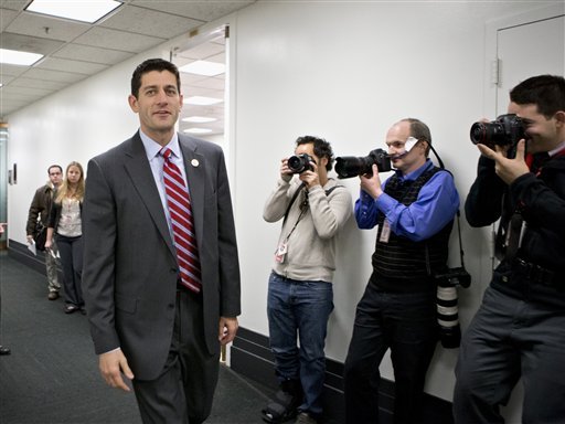 FILE - This Nov. 28, 2012 file photo shows House Budget Committee Chairman Rep. Paul Ryan, R-Wis. walking on Capitol Hill in Washington.  House Republicans say they may seek a short-term extension of the government's debt limit in the next few weeks, a move that would avoid an immediate default by the Treasury. Ryan provided no details on the duration of any extension or conditions that might be attached as he appeared at a news conference during a break at a three-day retreat of the rank and file in historic Williamsburg, Va.  (AP Photo/J. Scott Applewhite, File)
