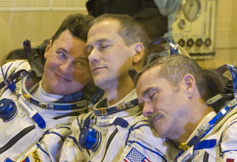   The International Space Station (ISS) crew members, from left: Russian cosmonaut Roman Romanenko, U.S. astronaut Thomas Marshburn and Canadian astronaut Chris Hadfield joke during their talk with relatives after putting on their space suits at the Baikonur cosmodrome Kazakhstan Wednesday, Dec. 19, 2012. (AP Photo/ Shamil Zhumatov, pool)  