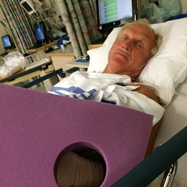 This photo provided by Greg Norman shows Norman resting in a hospital bed after a chainsaw accident.  Norman posted a photo to Instagram on Sunday, Sept. 14, 2014,  in which he was laying in a hospital bed with his left arm  heavily bandaged.  The Hall of Fame golfer and entrepreneur, was cutting back trees in his South Florida home when the weight of a branch pulled his left hand toward the chain saw. He said the blade hit him just below where a person would be wearing a wrist watch. He said doctors told him it missed his artery by a fraction of an inch. (AP Photo/Courtesy of Greg Norman) NO SALES