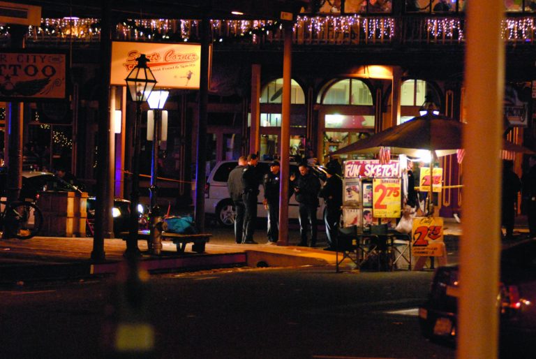 In this image provided by Robert Petersen police inspect the scene of a shooting outside the Sports Corner Cafe in Sacramento Calif. Monday Dec. 31, 2012. Police say two people died and three others were injured in a New Year's Eve shooting after a fight in a restaurant in the Old Sacramento area. After the shooting, police decided to cancel the area's midnight fireworks show, which were part of the New Year's Eve celebration. (AP Photo/Robert Petersen)