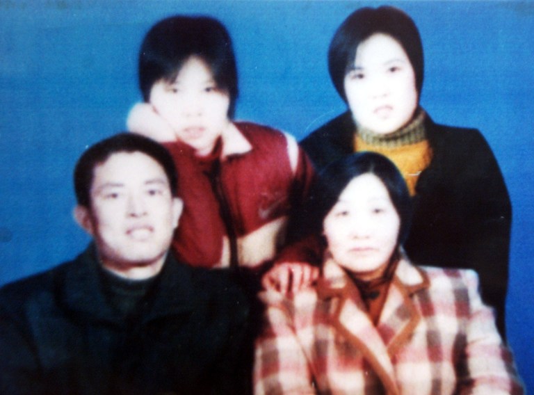   FILE - In this undated handout photo, Chinese Christian Gong Shengliang, bottom left, poses with unidentified family members at an unknown location in China. Family members of the charismatic Christian preacher whose church is banned as a cult in China are calling for his release from prison after he apparently suffered a stroke that left him unable to walk and speak normally. The family members of Gong petitioned government offices in Beijing this past week and released an open letter earlier this month after seeing his condition. (AP Photo/File)  