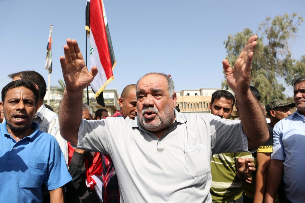 To stem extremists, Iraq to reduce Baghdad’s power