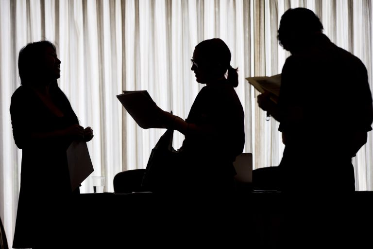 In this June 23, 2014 photo, recruiter Christina O, left, with New Western Acquisitions, meets with employment seekers during a job fair in Philadelphia. As the economic recovery enters its sixth year, many Americans don't feel better off. (AP Photo/Matt Rourke)
