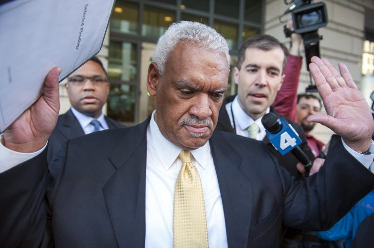 Jeffrey Thompson holds up his hands to indicate he will not speak to reporters as leaves federal court in Washington, after being charged Monday in a criminal information with two conspiracy offenses stemming from an ongoing investigation Monday. (AP/Cliff Owen)