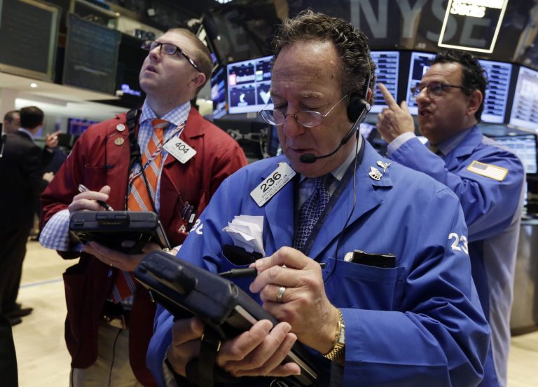 Trader Steven Kaplan, center, works on the floor of the New York Stock Exchange Friday, May 16, 2014. The stock market is little changed in early trading following sharp declines the previous day. (AP Photo/Richard Drew)