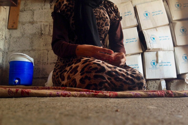 In this photo taken Wednesday, Oct. 8, 2014, a 15-year-old Yazidi girl captured by the Islamic State group and forcibly married to a militant in Syria sits on the floor of a one-room house she now shares with her family after escaping in early August, while speaking in an interview with The Associated Press in Maqluba, a hamlet near the Kurdish city of Dahuk, 260 miles (430 kilometers) northwest of Baghdad, Iraq. The girl was among hundreds of women and girls from the Yazidi religious minority captured by Islamic State fighters in early August when the militants overran their hometown of Sinjar in northwestern Iraq. Hundreds were killed in the attack, and tens of thousands fled for their lives, most to Kurdish-held parts of the north. (AP Photo/Dalton Bennett)