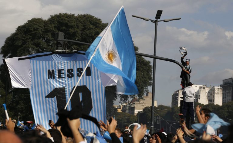 Soccer fans gather at the obelisk to welcome home Argentina's soccer team, before it was announced that the team won't be coming to this landmark for a welcome ceremony after they landed at the airport in Buenos Aires, Argentina, Monday, July 14, 2014. Fans came out to welcome home Argentina's team after it was defeated 1-0 by Germany at the Brazil World Cup final match on Sunday. (AP Photo/Jorge Saenz)