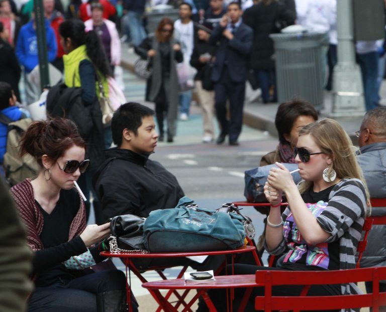 FILE--In this Feb. 18, 2011 file photo, Katherin Burns, 19, left, smokes with Shannon Roy, 18, right, in the pedestrian plaza in Times Square in New York. New York City's Department of Health released data Monday, Sept. 15, 2014 showing that for the first time since 2007 there are more than 1 million smokers in the city. (AP Photo/Frank Franklin II, file)
