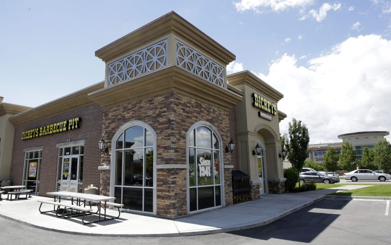 FILE - This Aug. 14, 2014, file photo, shows the exterior of Dickey's Barbecue Pit in South Jordan, Utah. No charges will be filed in a case involving a woman who nearly died after unknowingly drinking iced tea mixed with chemicals at a suburban Salt Lake City restaurant, prosecutors said Friday. Prosecutors determined after reviewing an extensive investigation by the South Jordan Police Department that there was no evidence of criminal wrongdoing, Salt Lake County Attorney Sim Gill said Friday in a short news release. (AP Photo/Rick Bowmer, File)