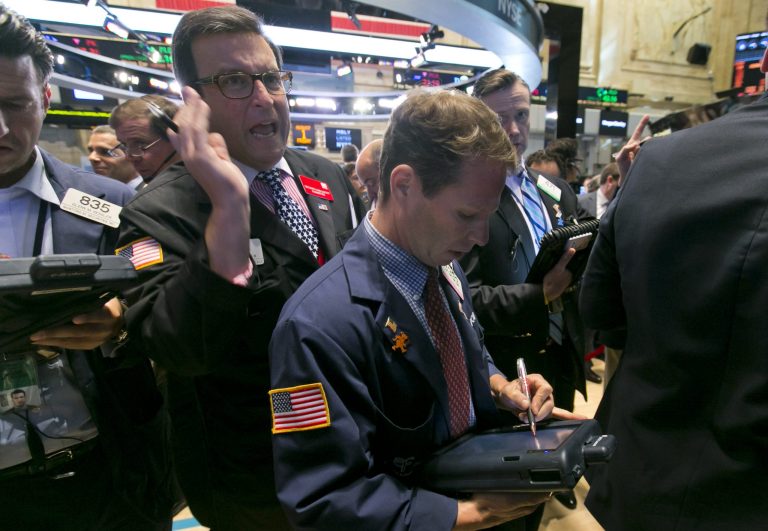 Trader Benedict Willis, left, calls out as he works on the floor of the New York Stock Exchange Friday, Aug. 1, 2014.  U.S. markets steadied on Friday a day after a major sell-off. Investors focused on a relatively strong jobs report, which showed the U.S. economy created 209,000 jobs in July, the sixth straight month of job growth above 200,000. (AP Photo/Richard Drew)