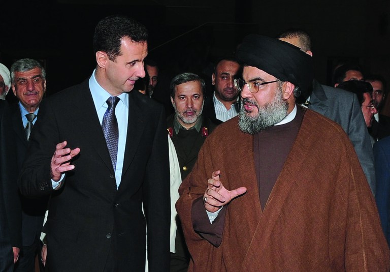 FILE -- In this Thursday February 25, 2010 file photo, released by the Syrian official news agency SANA, Hezbollah leader sheik Hassan Nasrallah, right, speaks with Syrian President Bashar Assad, left, upon their arrival for a dinner, in Damascus, Syria. The powerful alliance of Iran, Syria and militant groups Hezbollah and Hamas, once dubbed the 