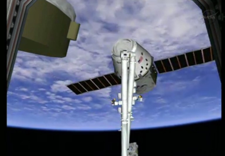 This frame grab made available by NASA TV shows a view of the SpaceX Dragon capsule on the end of the International Space Station's robotic arm, Sunday, March 3, 2013. SpaceX, the California-based company founded by billionaire Elon Musk, had to struggle with the Dragon following its launch Friday from Cape Canaveral. The spacecraft is delivering more than 1 ton of supplies to the the International Space Station. (AP Photo/NASA TV)