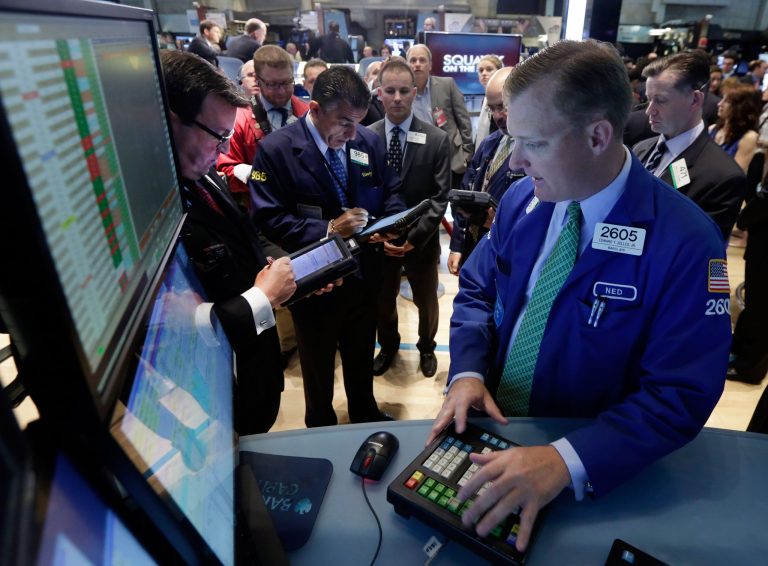 Specialist Edward Zelles, foreground, works with traders at his post on the floor of the New York Stock Exchange Monday, June 2, 2014. Stocks were moving slightly lower in early trading Monday following the release of a closely watched report that showed an unexpected slowdown in U.S. manufacturing last month. The market is coming off record highs last week. (AP Photo/Richard Drew)