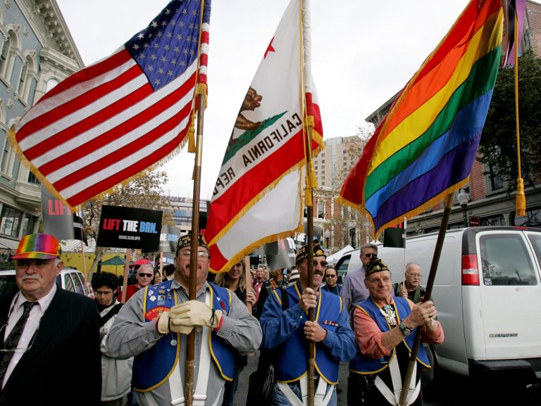 Gay veterans hold the U.S. flag, and the Gay and Lesbian Rainbow Coalition flag, during a march on Veterans Day.Â The Air Force will make it more difficult to discharge transgender troops -- a move that puts the Pentagon a step closer to allowing transgender people to serve openly in the military.Â (AP Photo/Paul Sakuma)