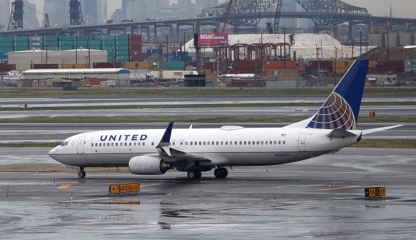 Physician who was dragged off flight settles with United
