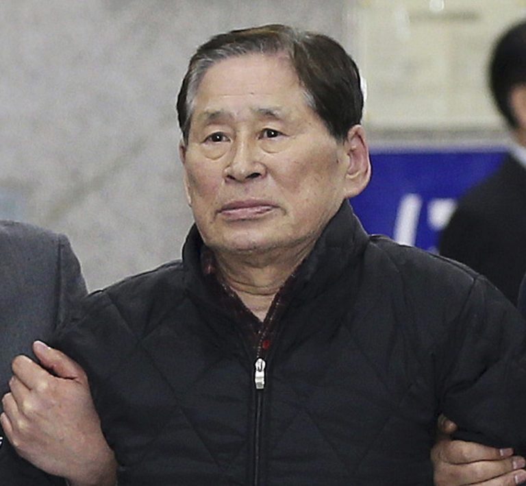 FILE - In this April 17, 2014 file photo, Kim Han-sik, CEO of Chonghaejin Marine Co. Ltd., which owns the sunken ferry Sewol, is escorted by helpers to hold a press conference at Incheon Port International Passenger Terminal in Incheon, South Korea. Kim, 71, did not deny that the ferry was overloaded with cargo and had been redesigned, but contended that it was questionable whether those factors led to the sinking, according to his lawyer, Kang Seok-won. Prosecutors on Friday said the CEO and four employees of the operator of the sunken ferry caused the accident by overloading the ship with poorly stowed cargo after a risky redesign and neglecting safety by spending less than $2 last year on crew training. (AP Photo/Yonhap, File)  KOREA OUT