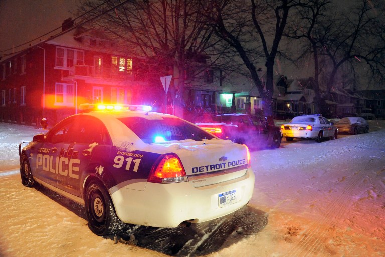 Detroit Police vehicles are parked in a neighborhood in Detroit where a 4-year-old boy was shot by his 4-year-old cousin with a rifle. (AP Photo/Detroit News, Jose Juarez)