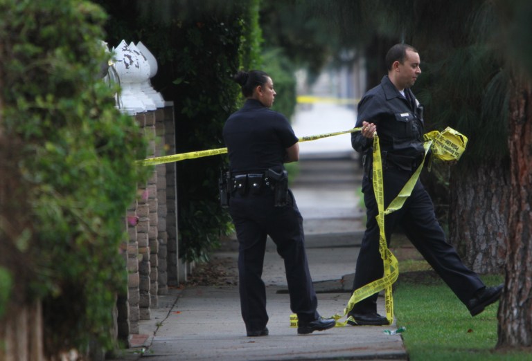   Police respond to a report of a shooting after the bodies of four people were found outside a boarding house in Northridge, Calif., Sunday, Dec. 2, 2012. (AP Photo/Los Angeles Times, Francine Orr) MANDATORY CREDIT NO MAGS, NO SALES NO FOREIGN NO TELEVISION, INTERNET. LOS ANGELES DAILY NEWS, ORANGE COUNTY REGISTER, VENTURA COUNTY STAR, INLAND VALLEY DAILY BULLETIN, AND LA OPINION OUT  