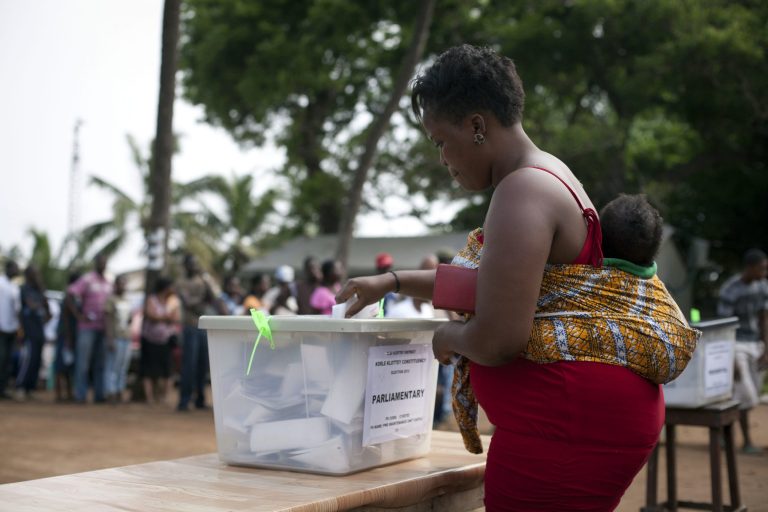   A woman casts her vote in parliamentary and presidential elections at an outdoor polling station in Accra, Ghana, Friday, Dec. 7, 2012. Ghanaians went to the polls Friday to choose between four candidates, including President John Dramani Mahama, who inherited the top post in July after President John Atta Mills died in office, and Nana Akufo-Addo, who lost the presidency by less than one percent to Mills in 2008. With its coup era over and five peaceful elections under its belt, Ghana is expected to hold a peaceful poll as voters decide which candidate will ensure the country's new-found wealth reaches the poor and middle-class. (AP Photo/Gabriela Barnuevo)  