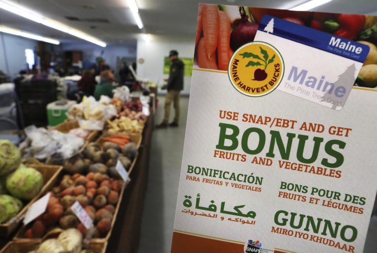 FILE - In this Friday, March 17, 2017, file photo, a sign advertises a program that allows food stamp recipients to use their EBT cards to shop at a farmer's market in Topsham, Maine. A proposal to curtail the nation's food stamp program would pinch families struggling to pay for groceries and ripple through other areas of the economy, including supermarkets and discounters. (AP Photo/Robert F. Bukaty, File)
