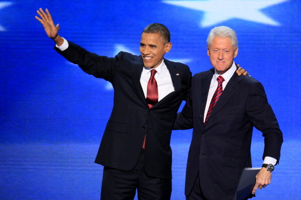 President Barack Obama, left, waves as former President Bill Clinton smiles on stage at the Democratic National Convention. (Getty Images)